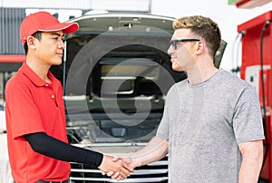 White caucasian car owner and Asian gas station worker man shake hands after succeed maintainance auto car engine and filling high