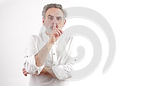 white caucasian man silencing someone or trying to say he wil keep a secret, medium shot, white background