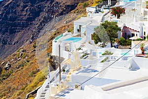 White cave villas upscale hotels with pools on Caldera cliff edge Santorini