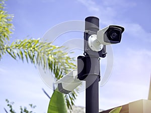 White CCTV cameras on the black pole