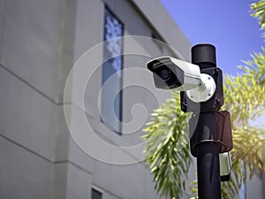 White CCTV cameras on the black pole