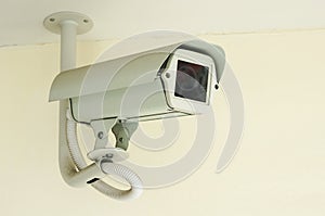White CCTV security camera on ceiling background ,Closed-circuit television record activity peoples
