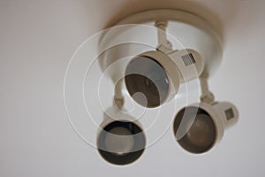 White ceiling lamp in the room. close-up of a white light lamp on the ceiling, with the possibility to adjust the angle of