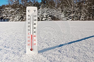 White celsius and fahrenheit scale thermometer in snow. Ambient temperature minus 1 degrees