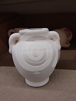 White ceramic amphora for candle or oil on Hanukkah holiday, children`s souvenir for coloring photo