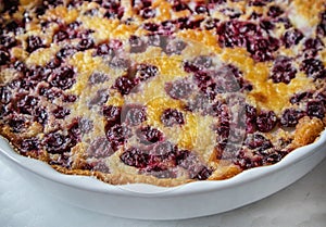 White ceramic baking dish with freshly baked cherry pie CLAFUTI, close-up