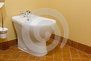 White ceramic bidet in modern bathroom.