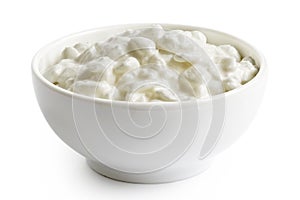 White ceramic bowl of chunky cottage cheese isolated on white photo