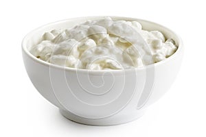 White ceramic bowl of chunky cottage cheese isolated on white