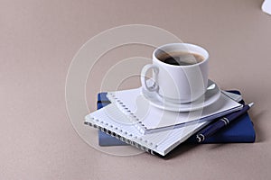 A white ceramic cup for hot beverage on light beige background