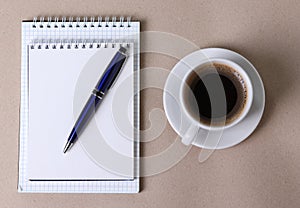 A white ceramic cup for hot beverage on light beige background