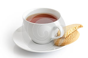 White ceramic cup and saucer with tea and shortbread biscuits. I