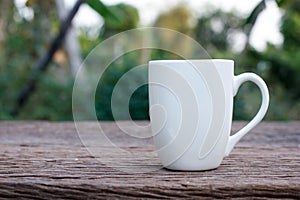 White ceramic cup on wood background