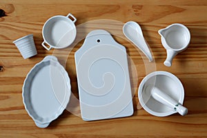 White ceramic kitchenware on wooden table - horizontal