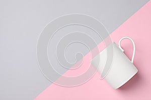 White ceramic mug on color background, top view and space for text