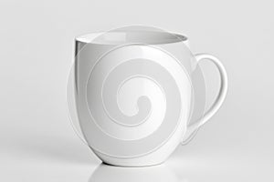 White ceramic mug with handle on plain background