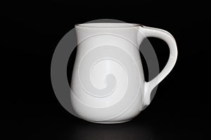 White ceramic mug isolated on a black background