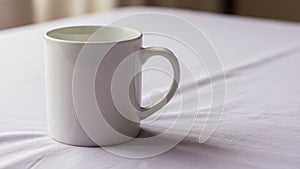 Cylindrical shape and a single handle placed on a soft light