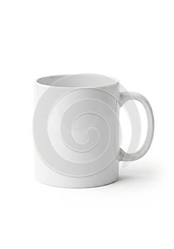 White ceramic mug with a smooth surface and a cylindrical shape. The handle is