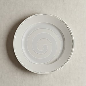 White ceramic plate with a simple circular design placed on a light-colored textured