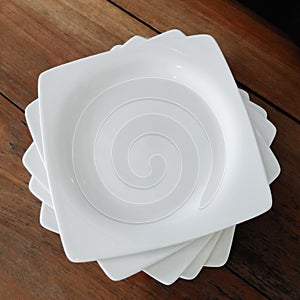 White ceramic plate on the wood table