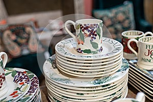 White ceramic plates on a shelf in  store. Designer ceramic plates with a pattern. tableware and eating concept. White jug with