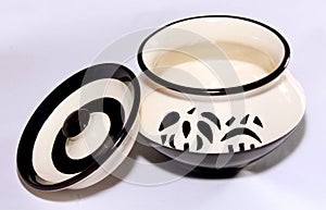 White ceramic pot pan with stencil designs.