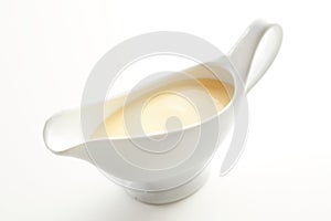 White ceramic sauce boat with Hollandaise sauce