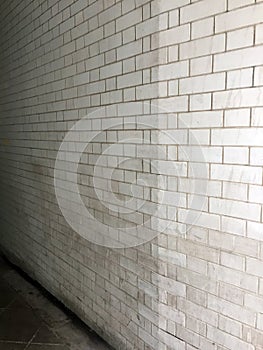 A White Ceramic Tiled Alley Way Wall