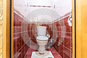 White ceramic toilet bowl in restroom