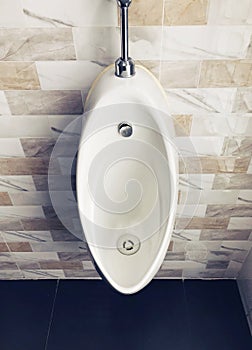 white ceramic urinal