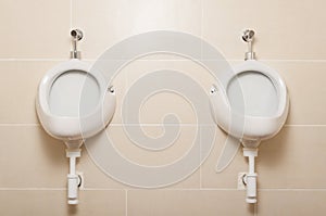 White ceramic urinals in for men in public toilet