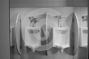 White ceramic urinals in the men`s room