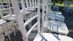 White ceremony chairs. Wedding detail. Before party set