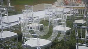 White ceremony plastic chairs. Wedding detail. Before party set. Luxury park reception. Graduation backyard. Elegant