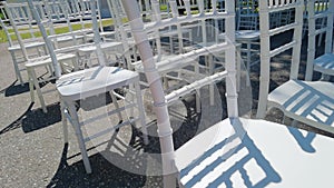 White ceremony wooden chairs. Wedding detail. Before party set. Luxury park