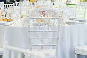 White chair and fancy table set for a wedding dinner