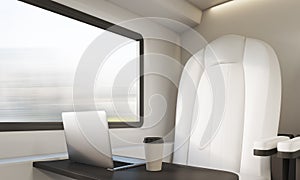 White chair, laptop and coffee in compartment