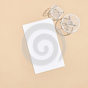 White chair and round table on beige background top view. White empty paper blank in sunshine with hard shadow. Cafe, restaurant,