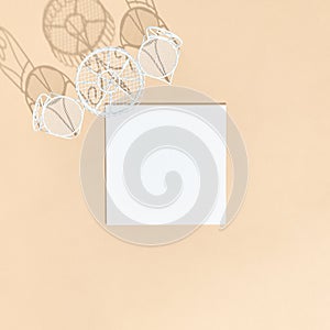 White chair and round table on beige background top view. White empty paper blank in sunshine with hard shadow. Cafe, restaurant,