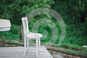 White chair stay alone on the wood floor