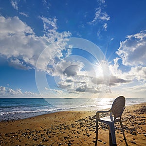 White chair stay on seandy sea beach at the early morning