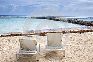 White chairs at beach in Guadeloupe