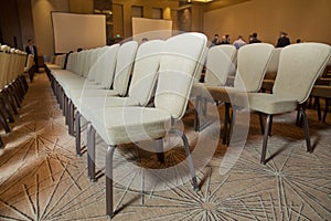 White chairs in the conference room. empty seat in conference meeting hall . White Chairs in the Conference Room just before a