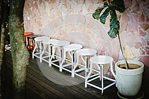 White chairs lined up on a wooden floor