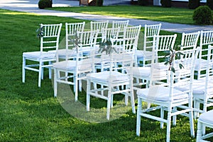 White Chairs at the Outdoor Wedding Ceremony Green Grass Background Party Celebrate Wedding Event