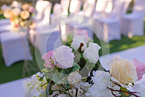 White chairs with pink bows for wedding exit registration.
