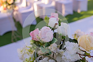 White chairs with pink bows for wedding exit registration.