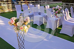 White chairs with pink bows for wedding exit registration.