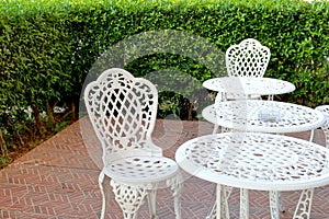 white chairs and table in lawn of garden